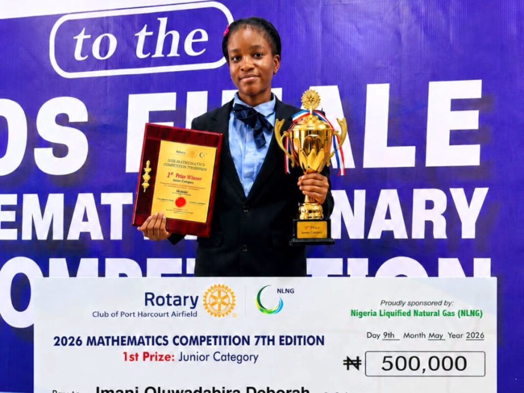 "NLNG 2026 Mathematics Competition 7th Edition winner holding 1st prize trophy and certificate sponsored by Nigeria LNG Rotary Club Port Harcourt
